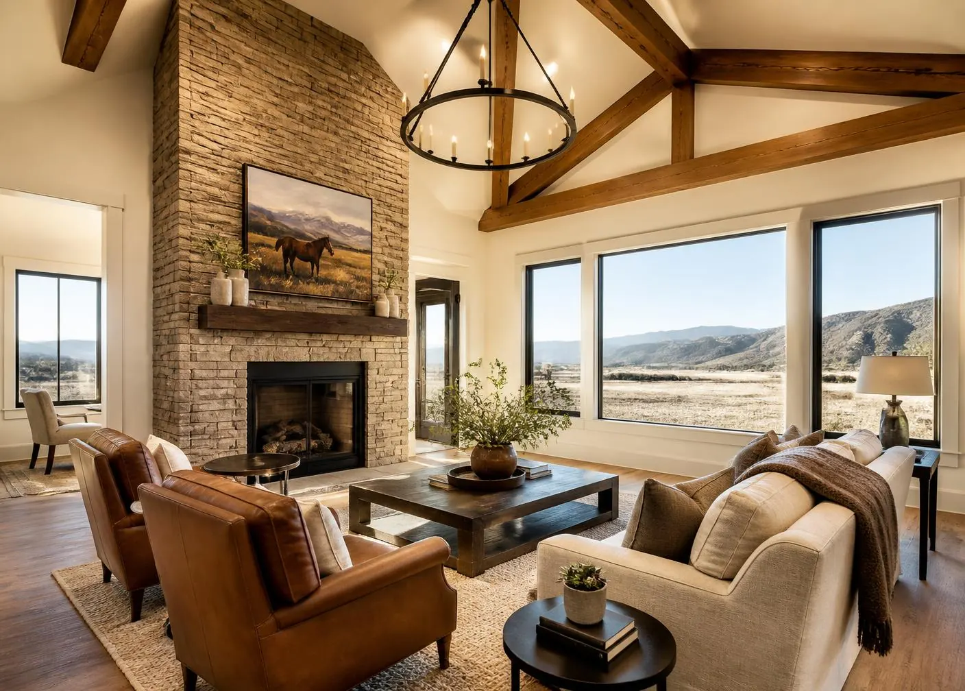Great room with vaulted wood beams and stone fireplace in a newly built Idaho home